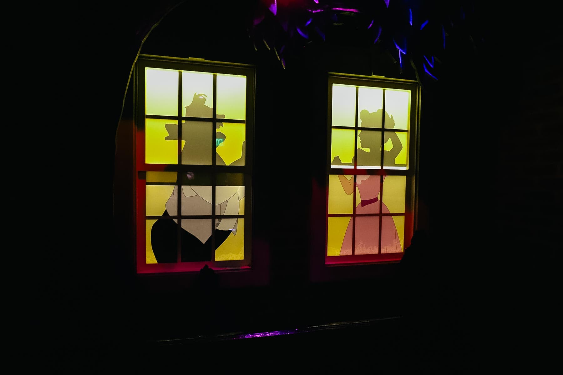 Mr. and Mrs. Darling prepare to go out from the window of Peter Pan's Flight Queue. 