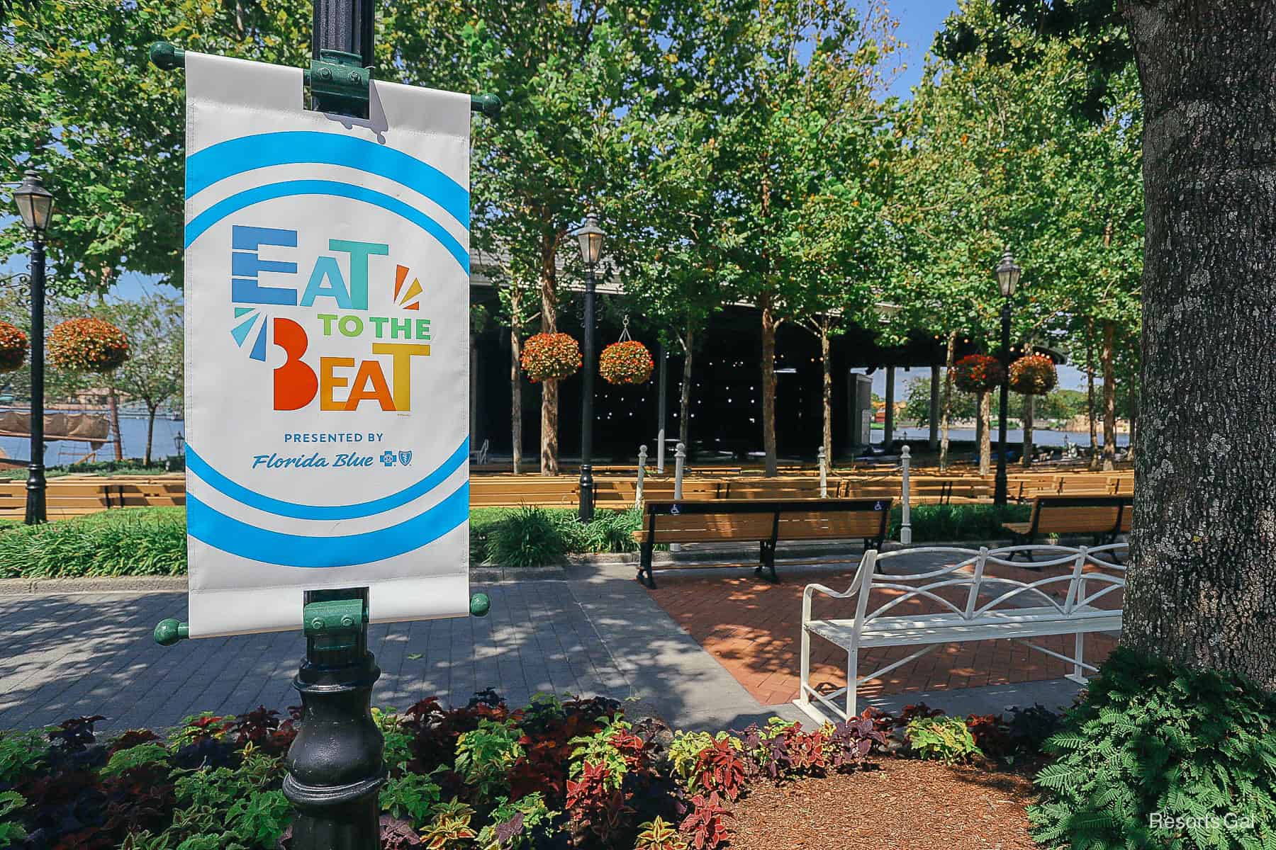 a banner with the Eat to the Beat concert series logo in front of the America Gardens Theater