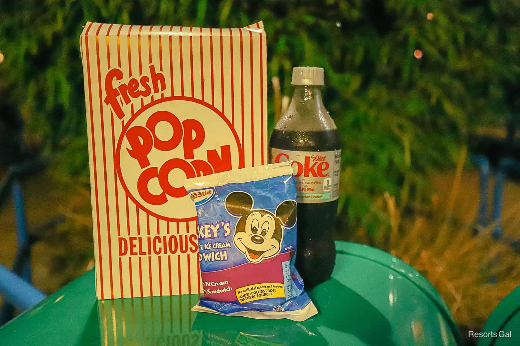 a box of popcorn, diet coke, and a Mickey's Ice Cream sandwich 