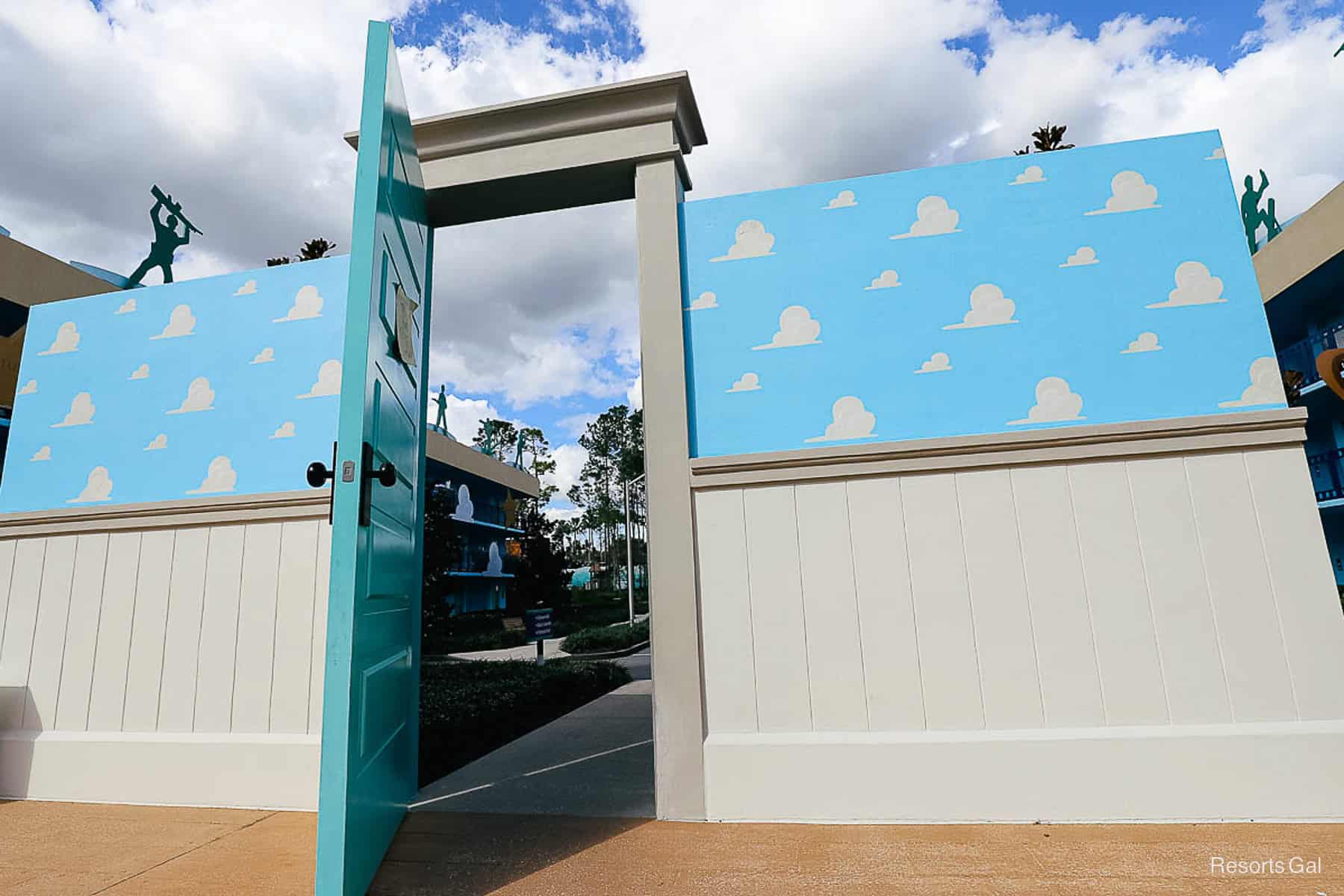 doorway to Andy's room with the blue sky wallpaper and cloud print 