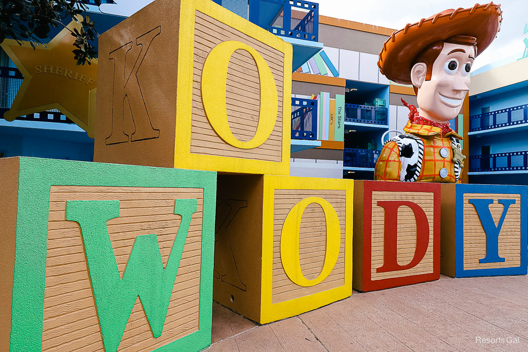 Woody next to large blocks that spell out Woody 