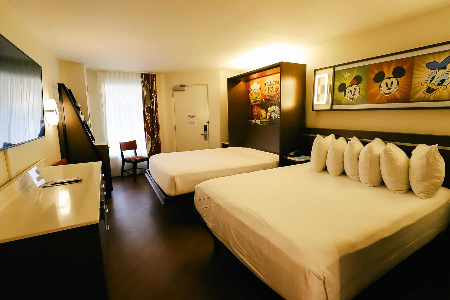 a room with a queen bed and a Murphy bed at All-Star Music Value Resort 