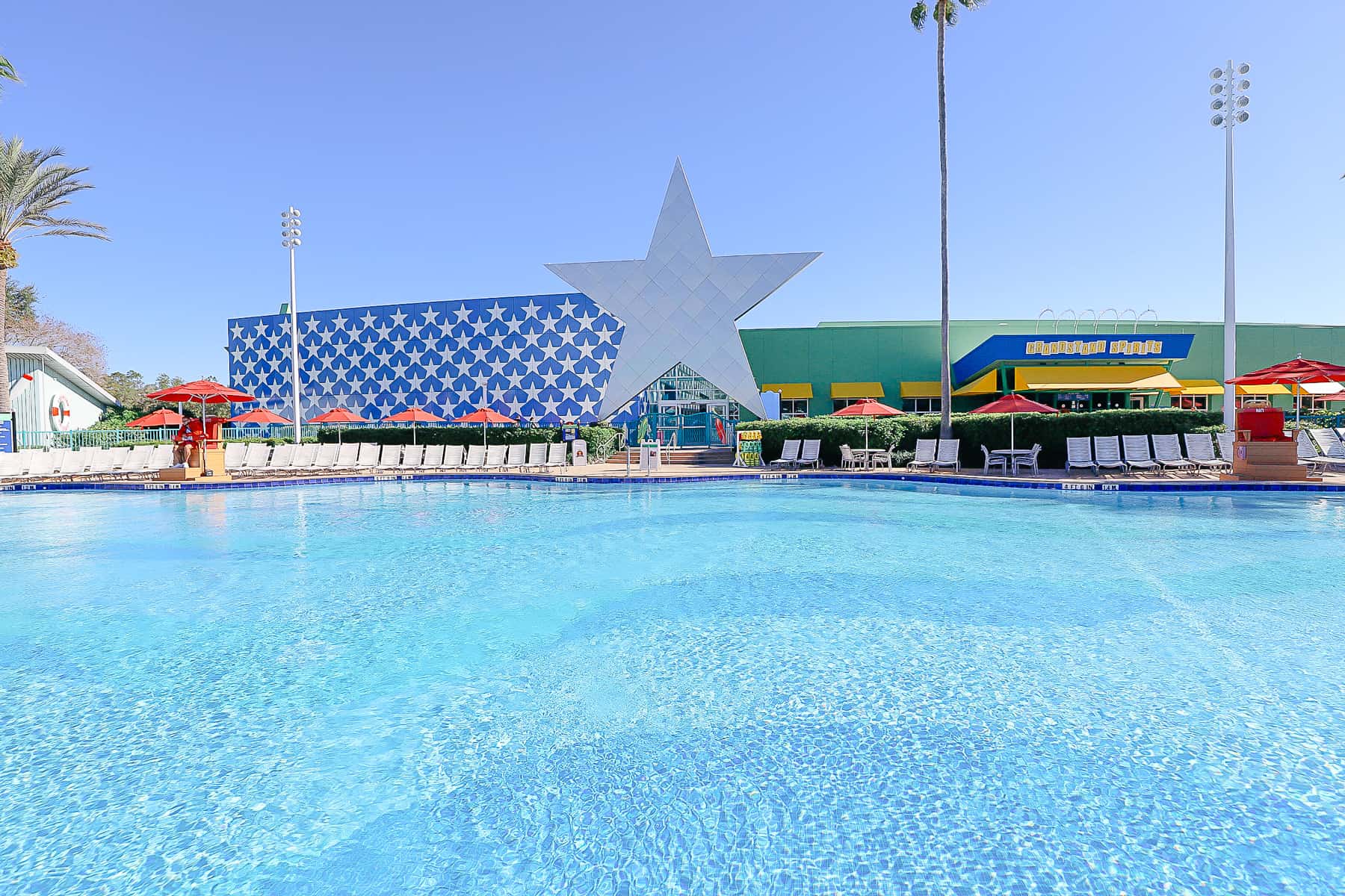 shows the exterior blue wall with stars at Disney's All-Star Sports from behind the pool 