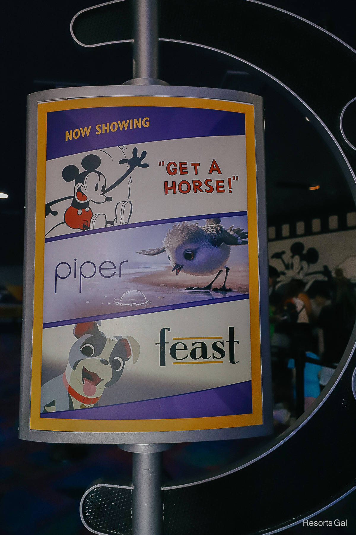 a sign that shows the films that play inside the Pixar Film Festival 