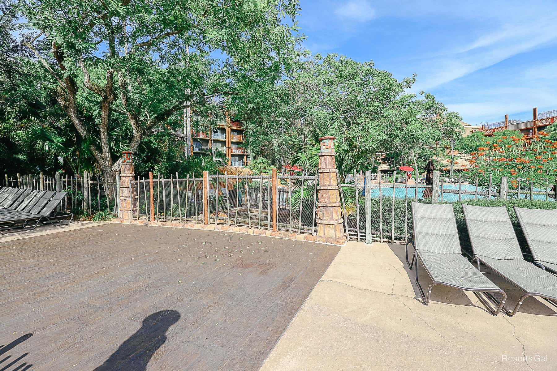 a bridge around the walkway to the pool 