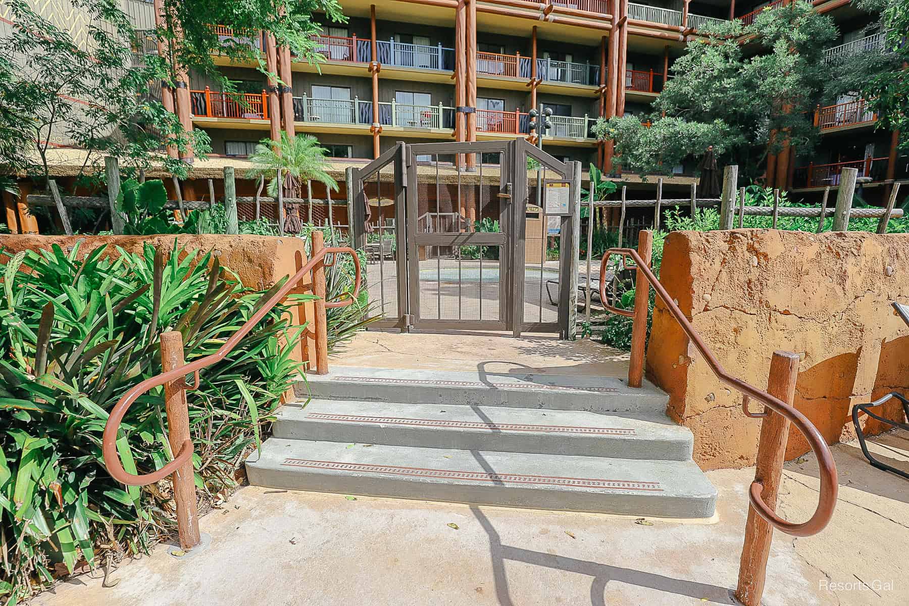 steps leading to a fenced kiddie pool area 