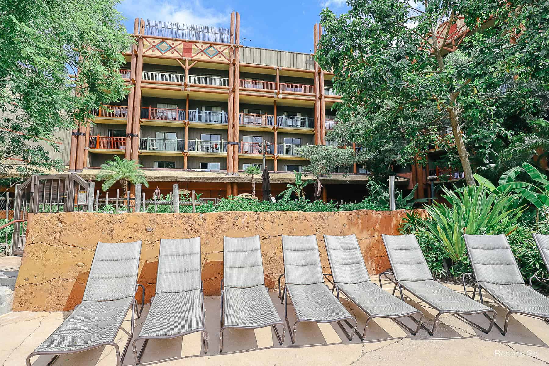 a row of lounge chairs in a sunny area 