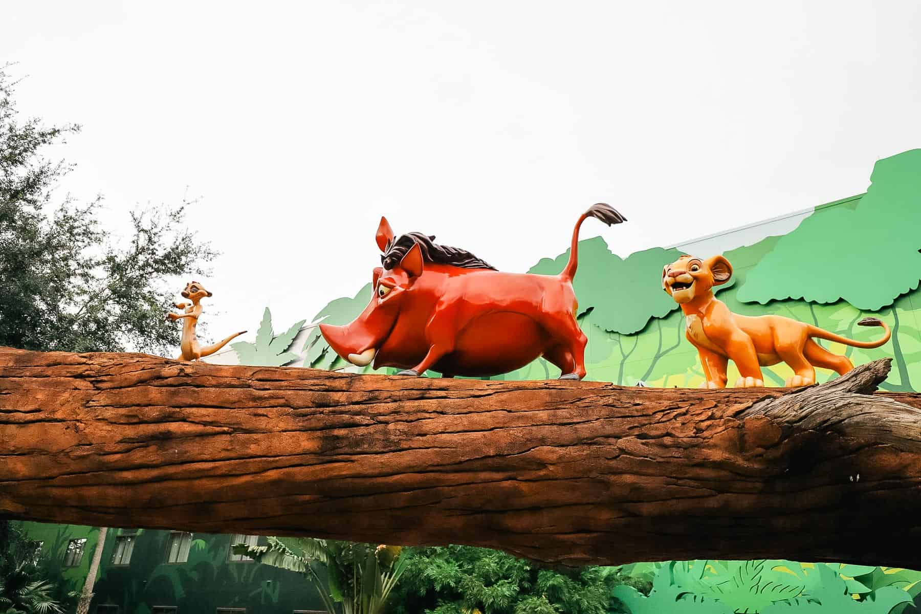 Timon, Pumbaa and Simba on a loag at The Lion King section with family suites at Disney's Art of Animation. 