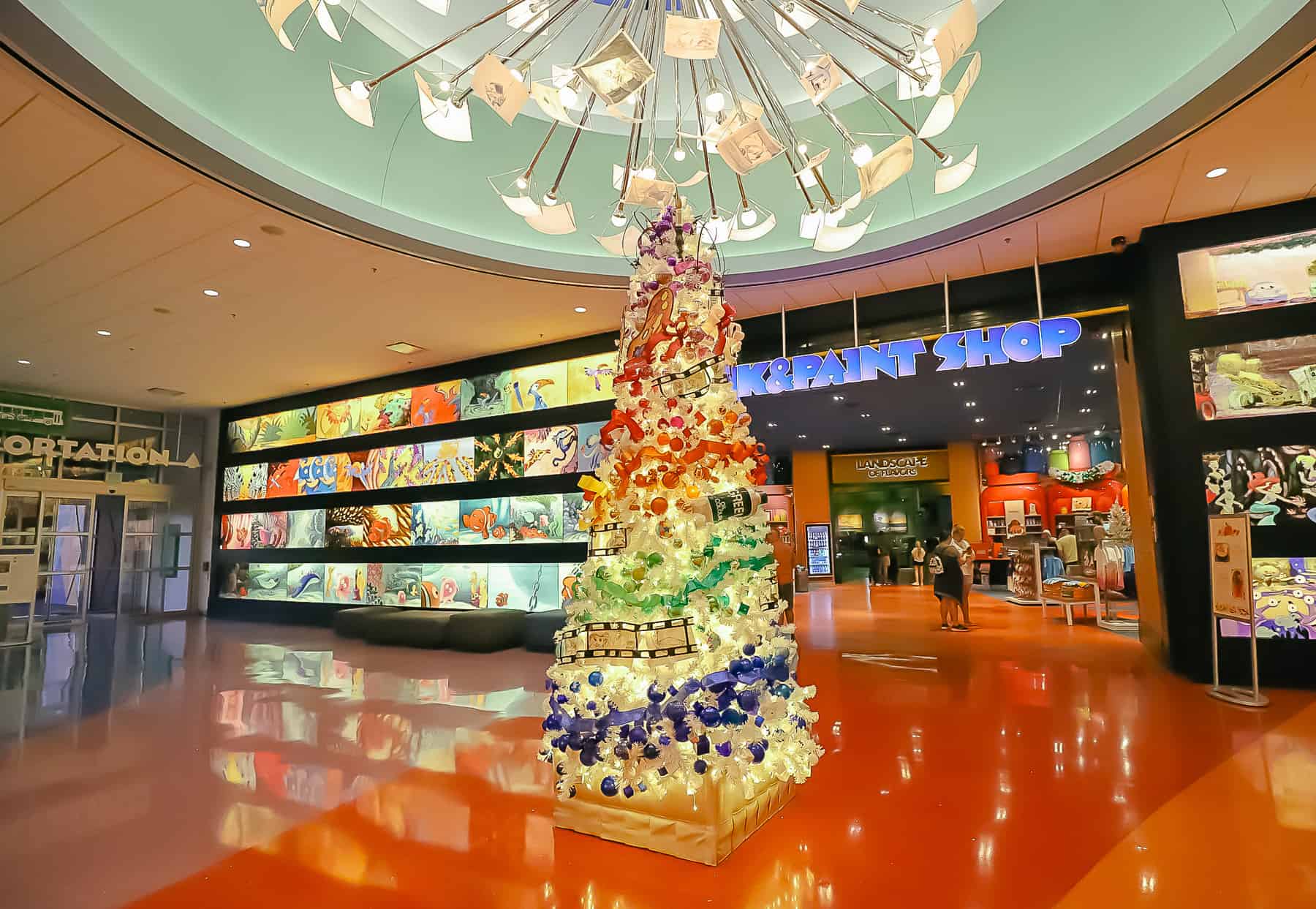 lobby of Art of Animation with the Christmas Tree sitting in the center 