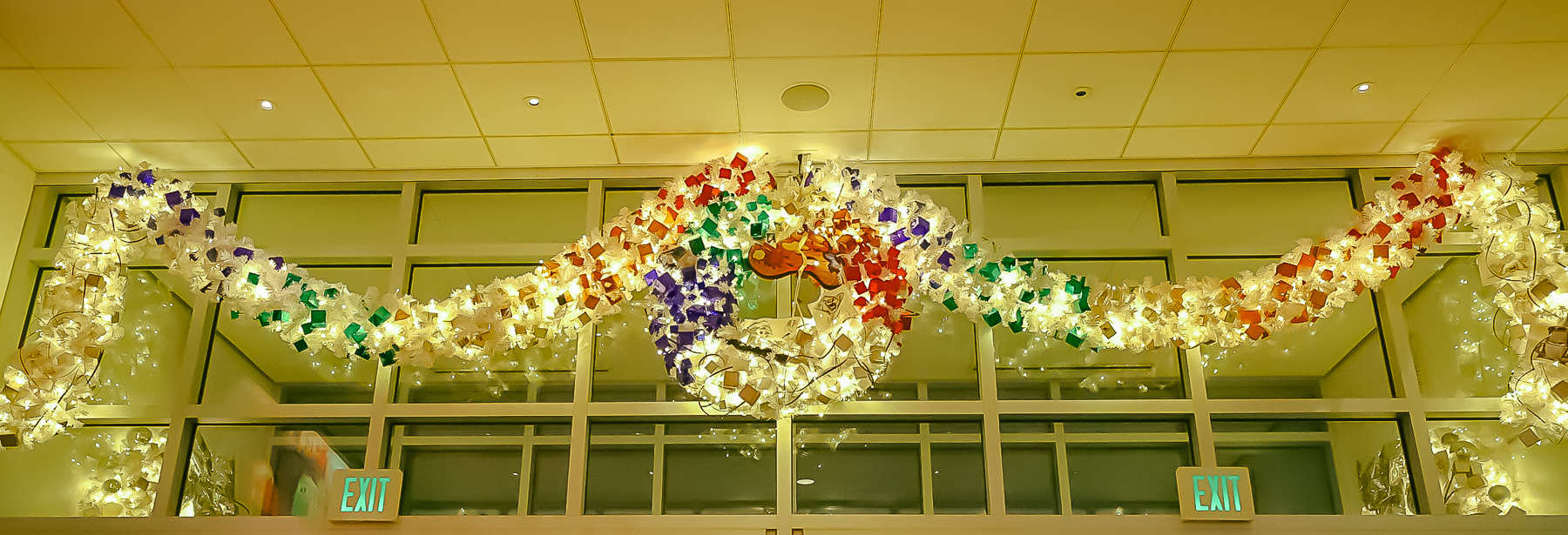 wreath and garland strung over the doors of Art of Animation's lobby 