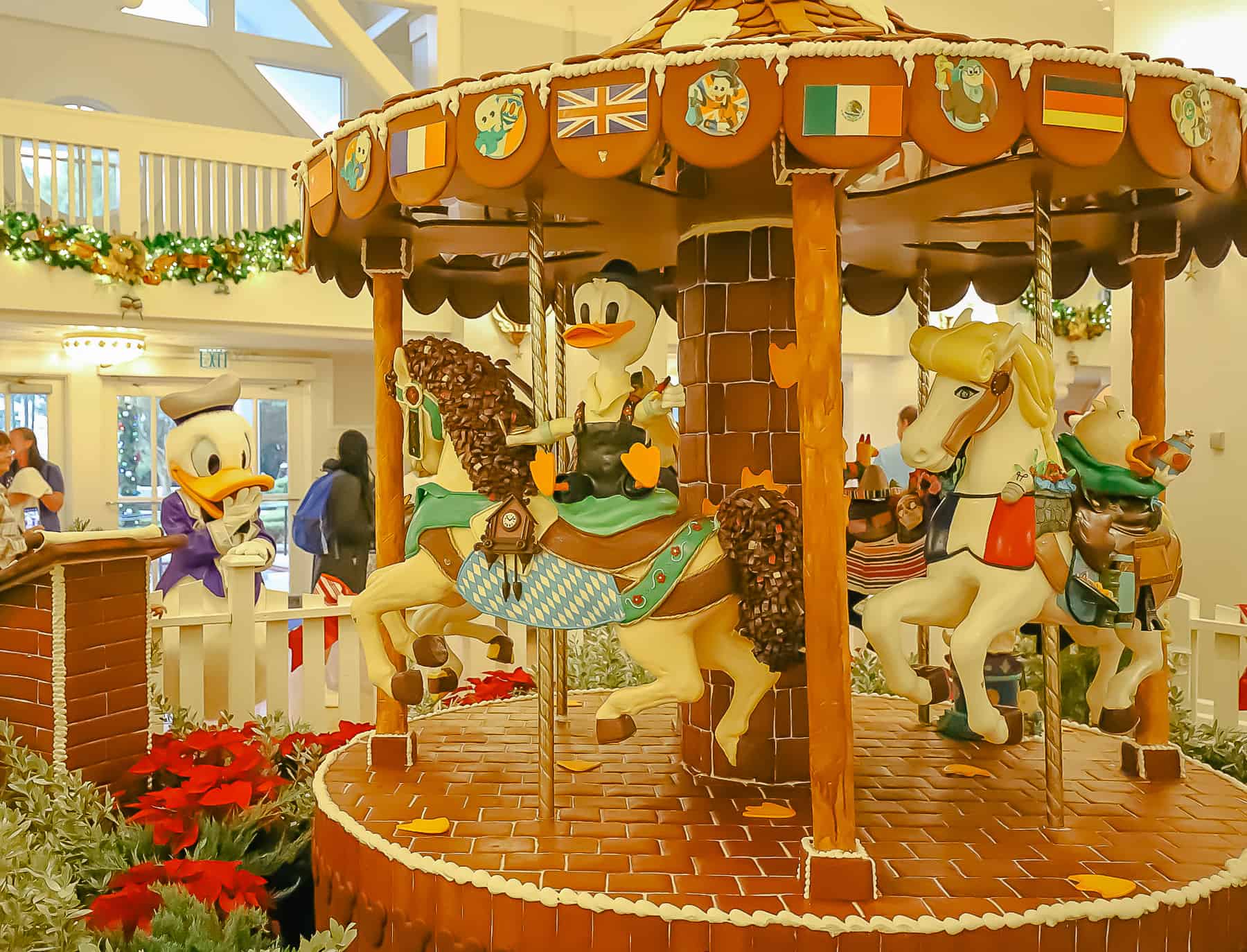 Disney's gingerbread carousel with Donald Duck looking on from a distance. 