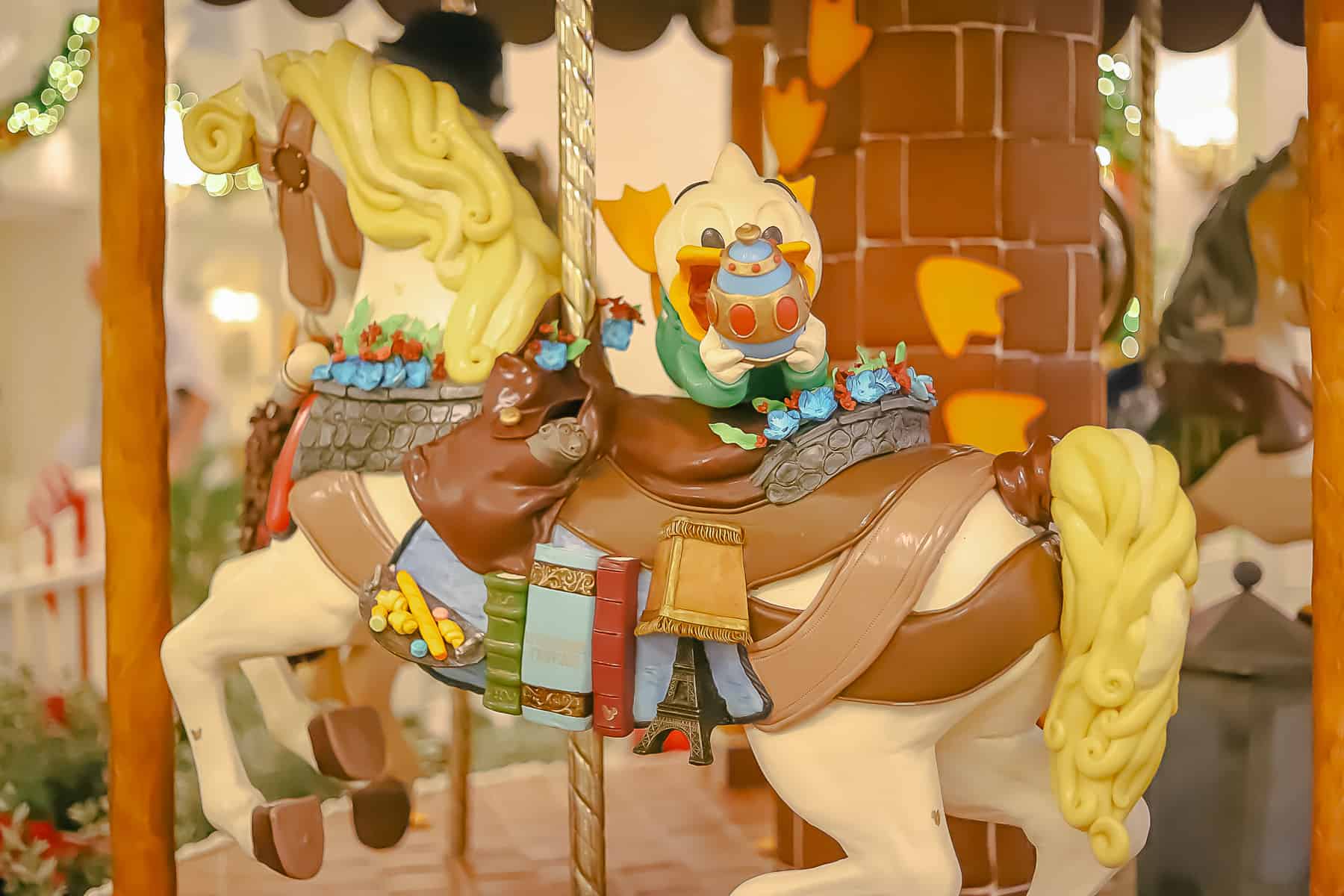A carousel pony representing the France Pavilion at Epcot with one of Donald's nephews. 
