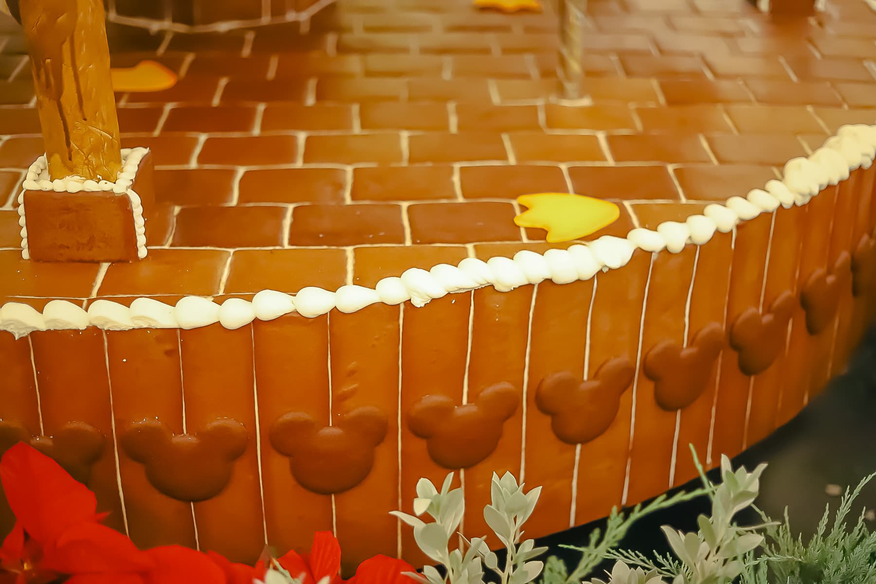 Shows gingerbread bricks with Mickey-shaped cutout on the gingerbread carousel. 