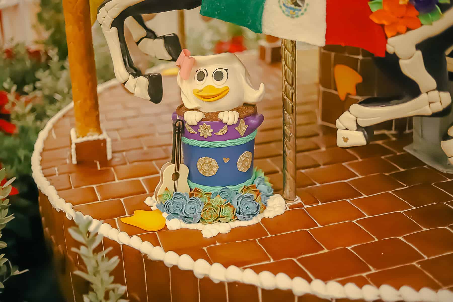 Webby, as part of the gingerbread display in a bucket surrounded by fondant succulents. 