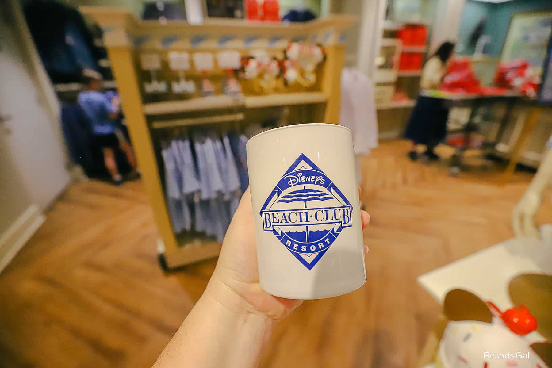 a candle with the Disney's Beach Club logo in bright blue 
