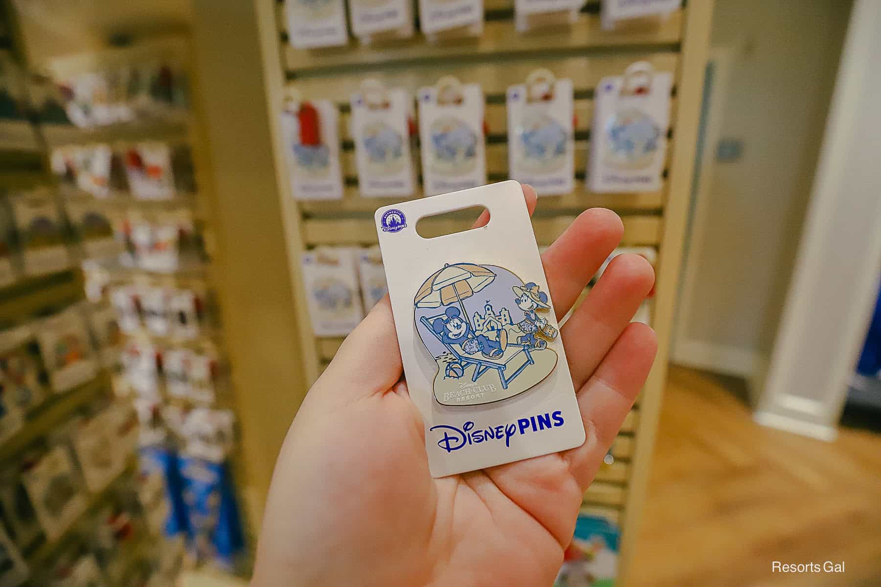 a Disney's Beach Club Resort pin with Mickey an Minnie Mouse at the beach 