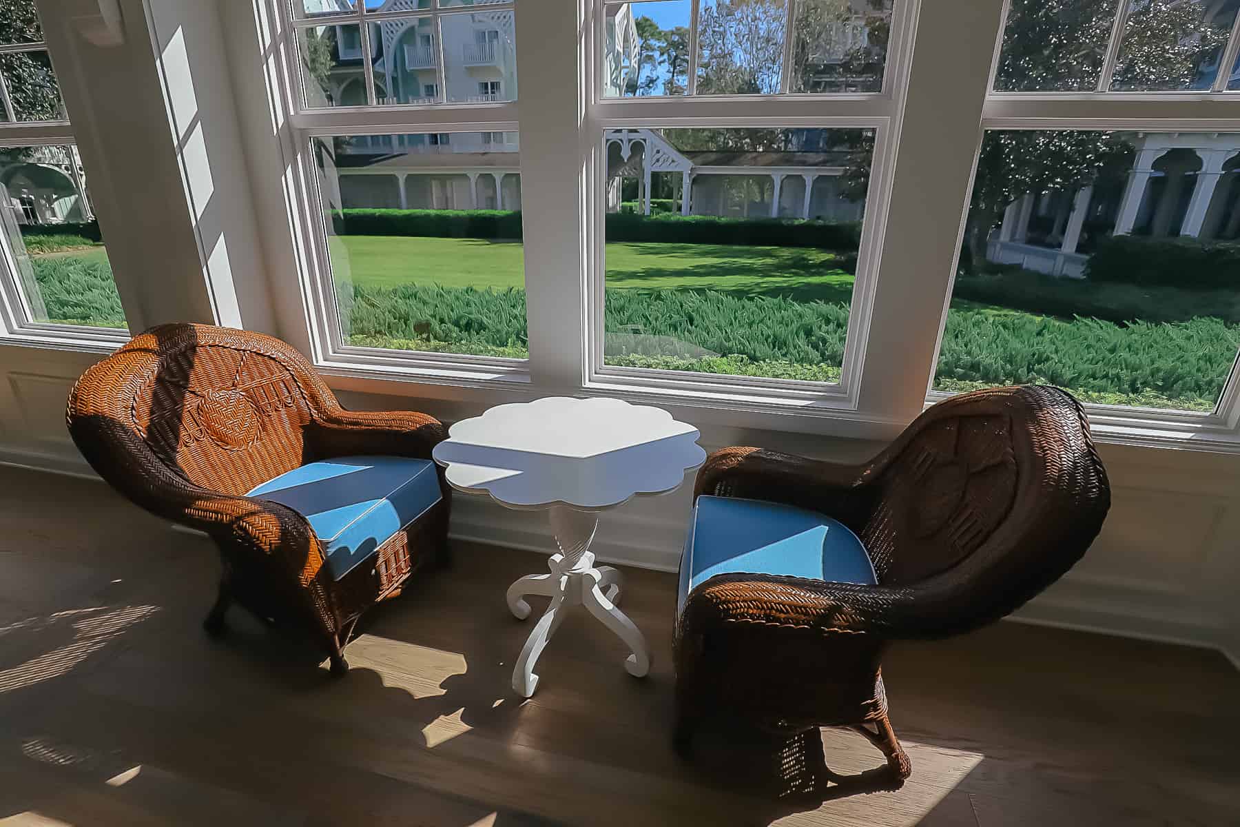 two wicker chairs with a table 