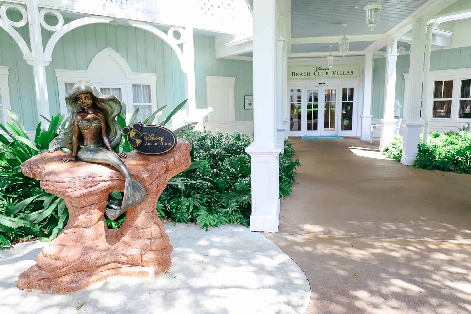 A statue of Ariel sitting on a rock at Disney's Beach Club. 