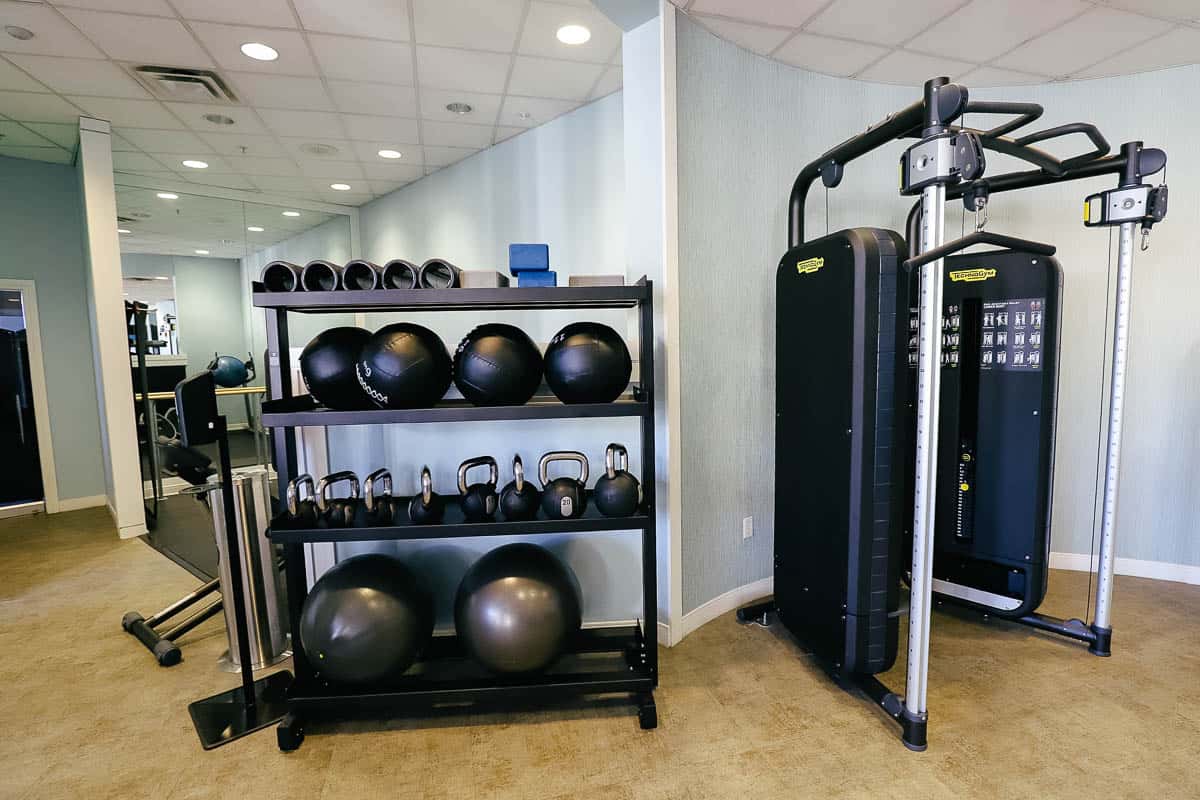 a rack with exercise balls and weights 