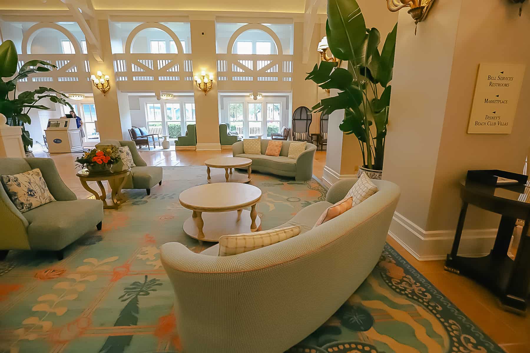 two small green and blue curved sofas and two chairs in the Beach Club lobby