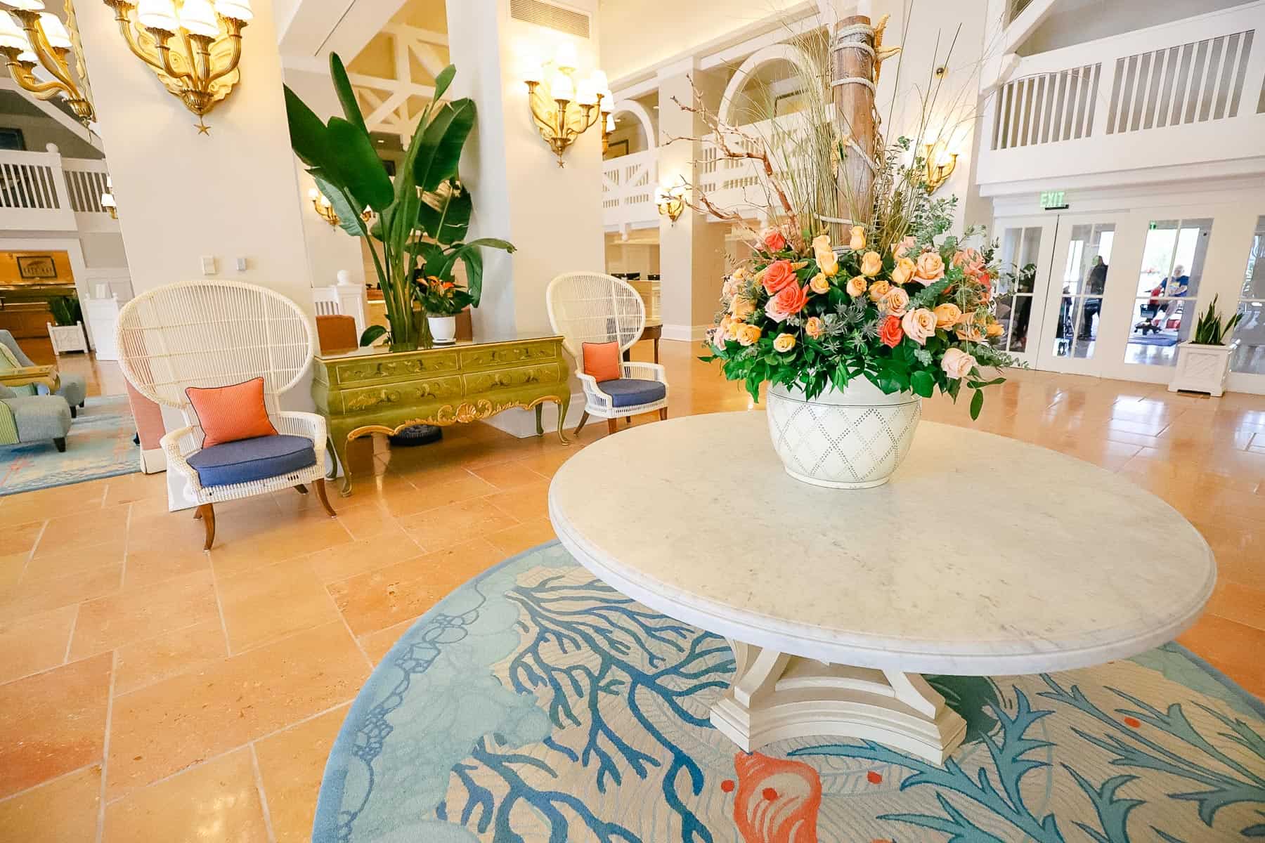 a round tabled with a bouquet of roses sitting in the lobby of Disney's Beach Club 