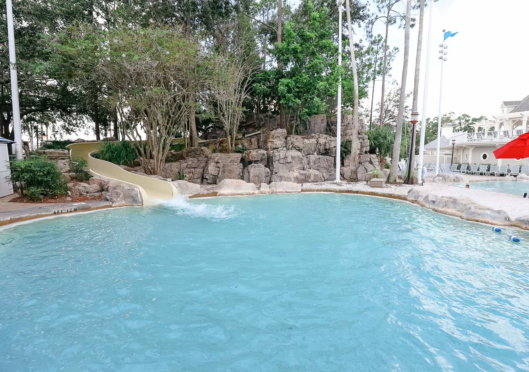 A waterslide exits to the pool. 