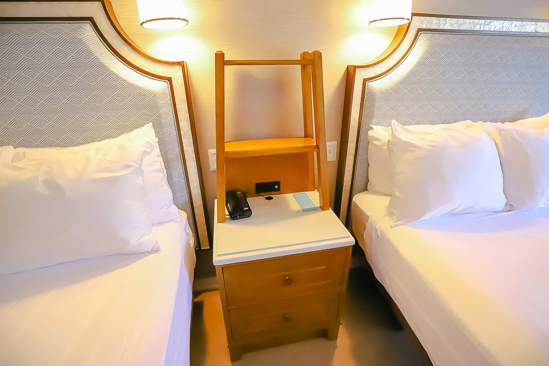 nightstand between the two queen beds