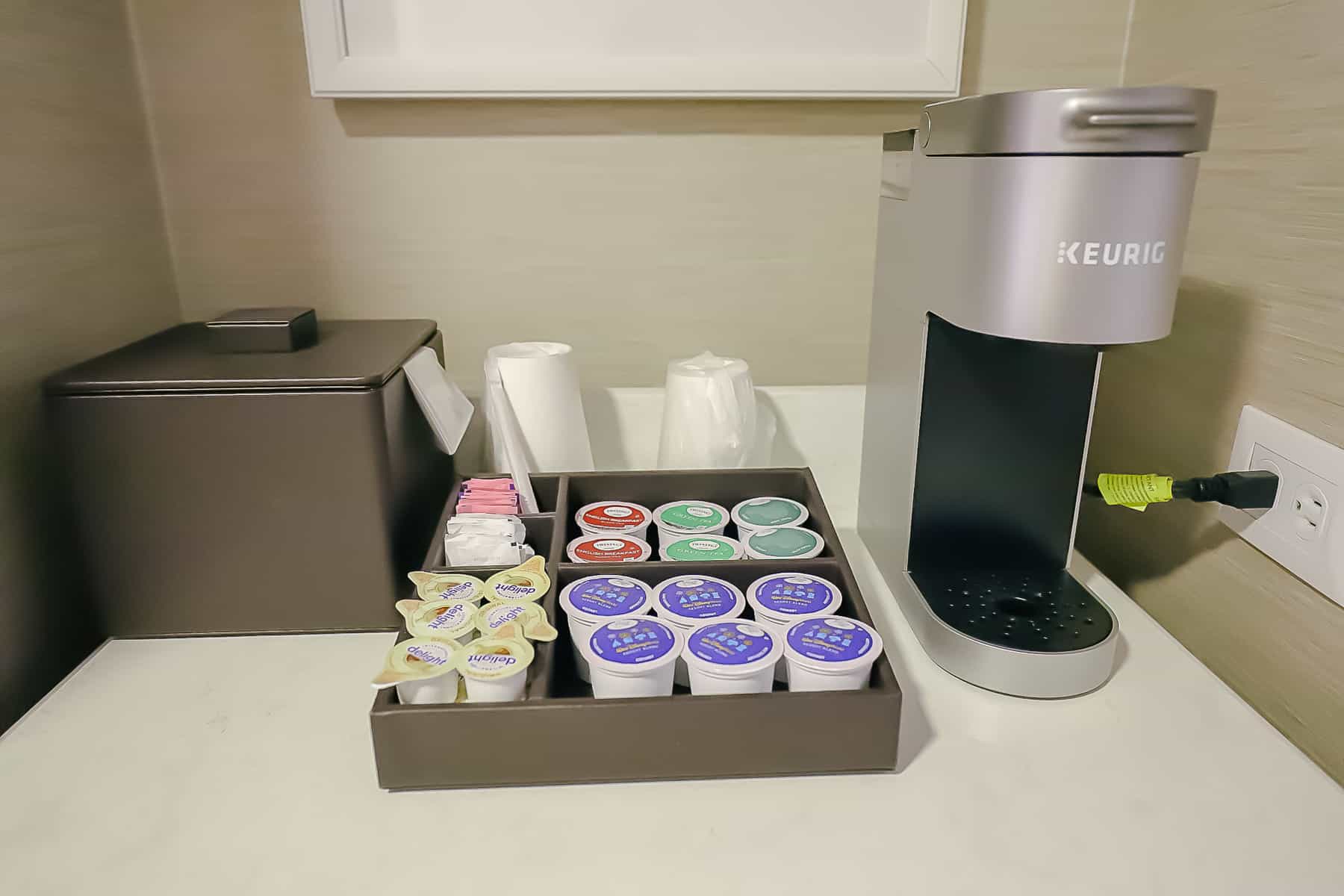 Keurig coffee maker, ice bucket and coffee accompaniments 