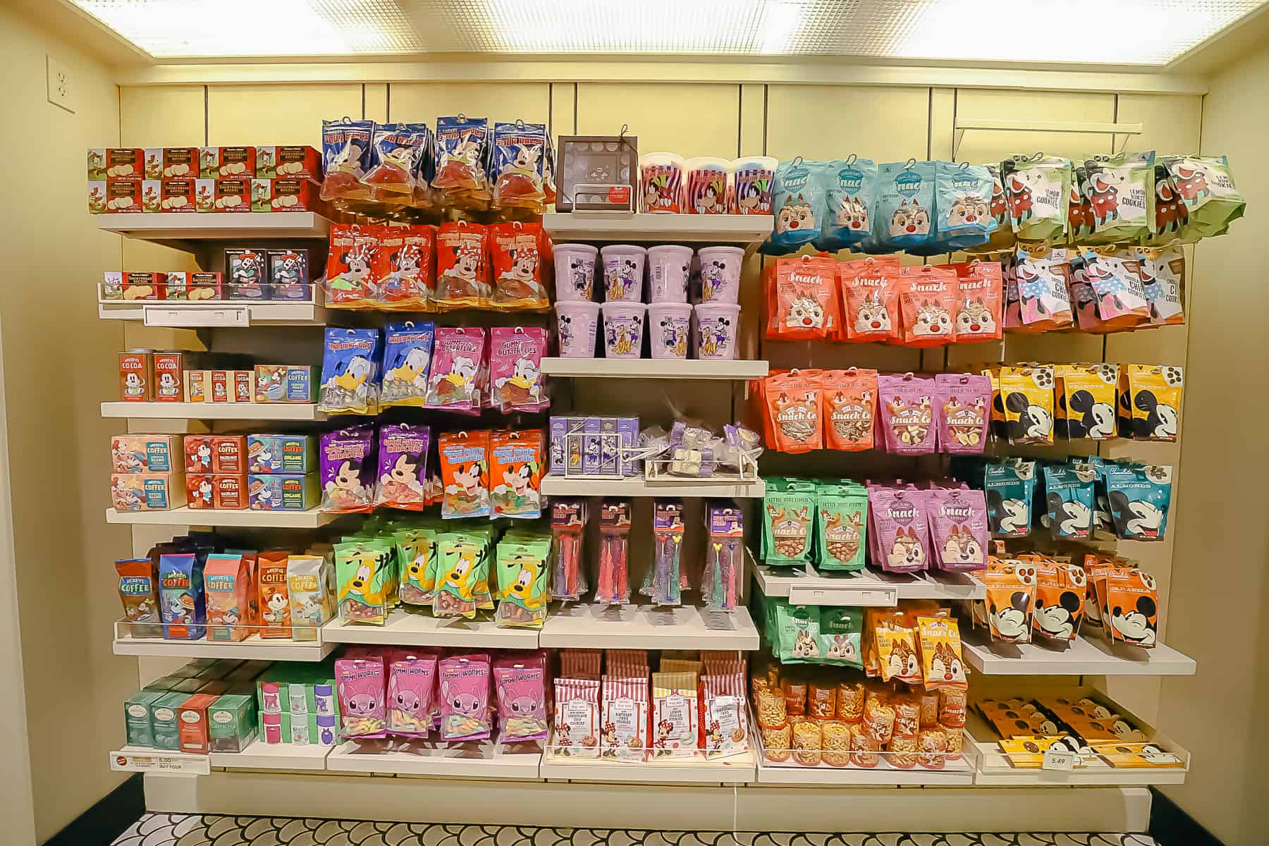 a wall with various kinds of Disney-branded candy on display 