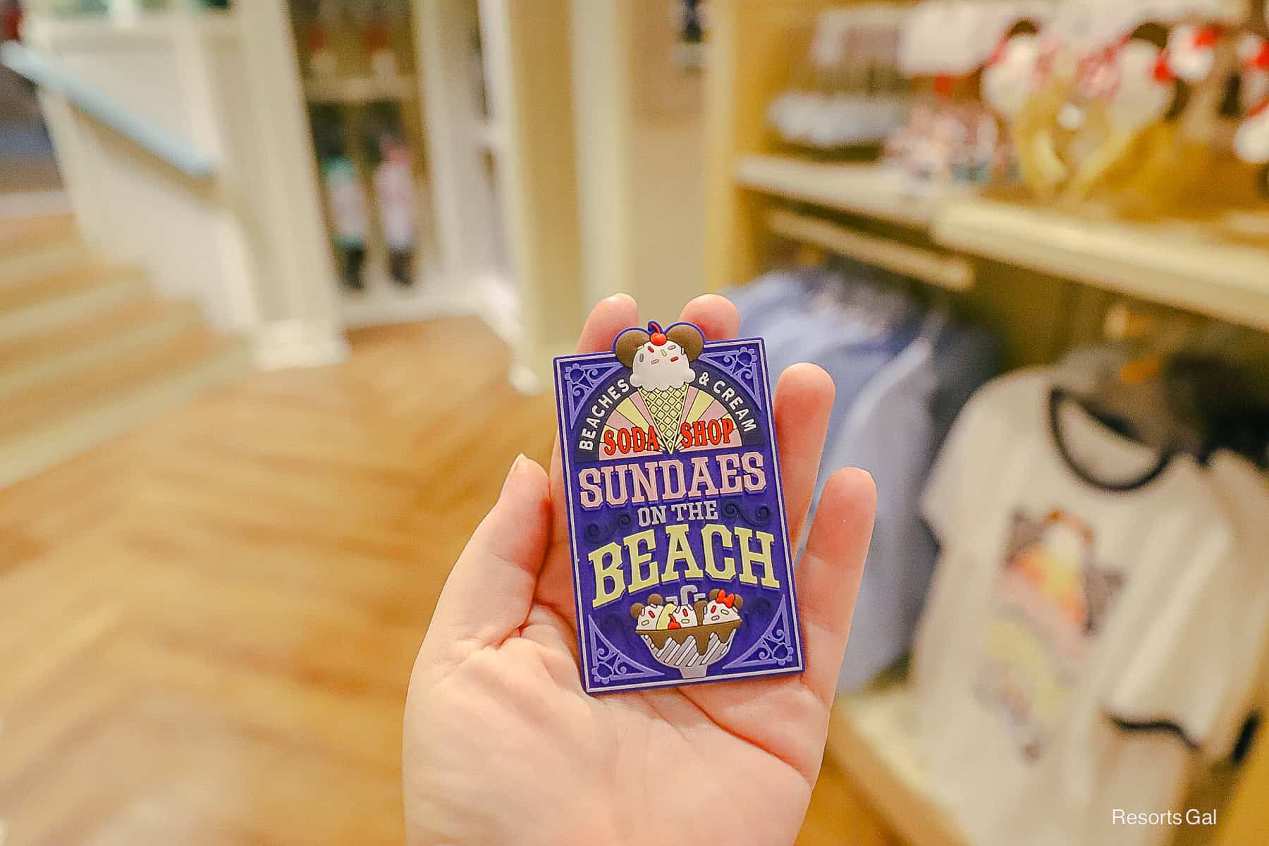a magnet with a blue background and the Beaches and Cream Soda Shop logo