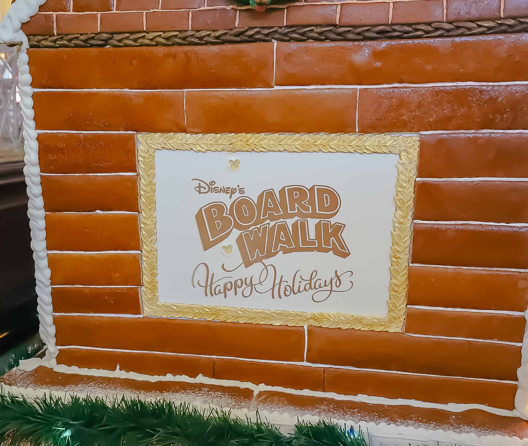 sign that says Disney's Boardwalk Happy Holidays in gold leaf 