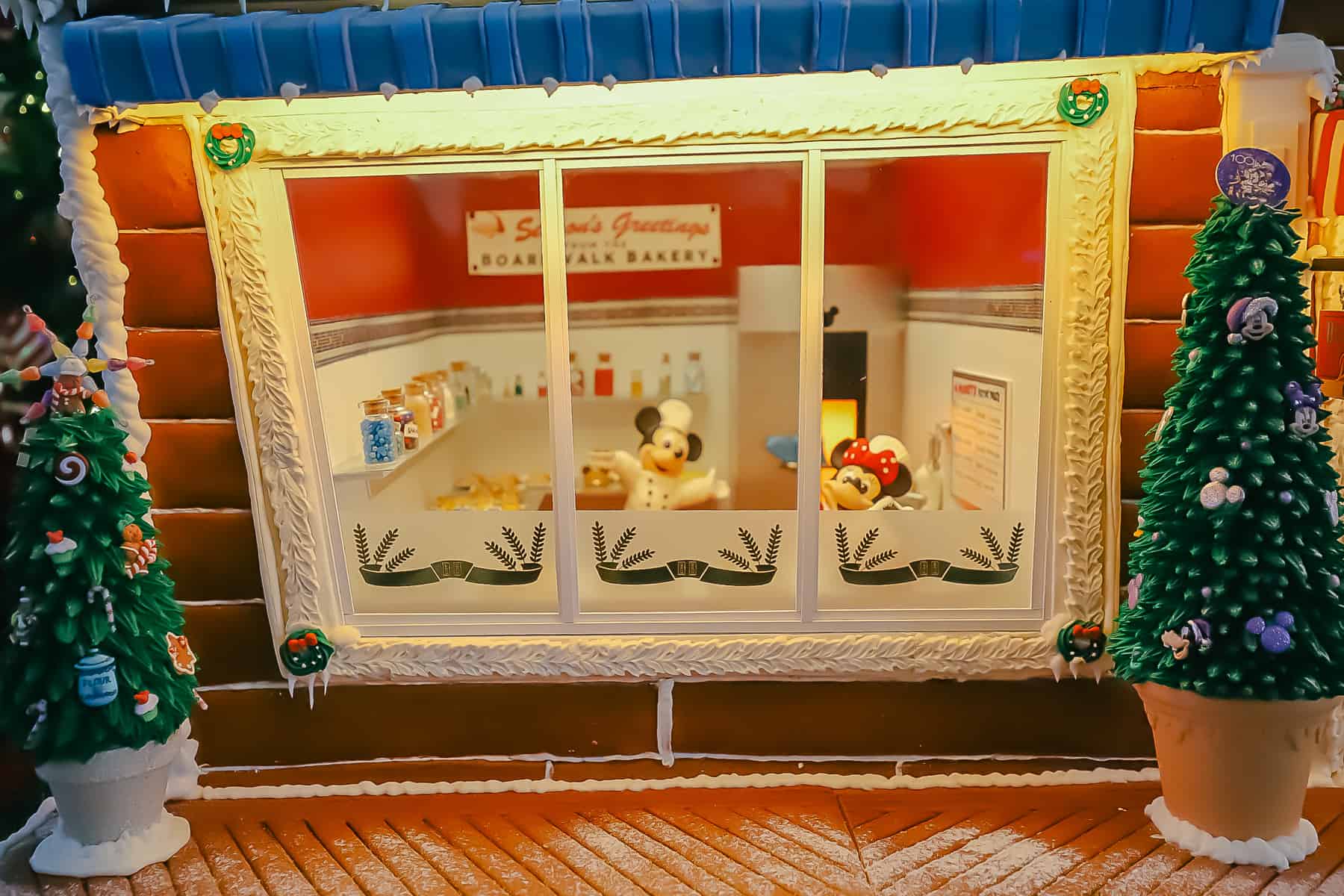 Inside the bakery window you can see Mickey and Minnie Mouse preparing items. 
