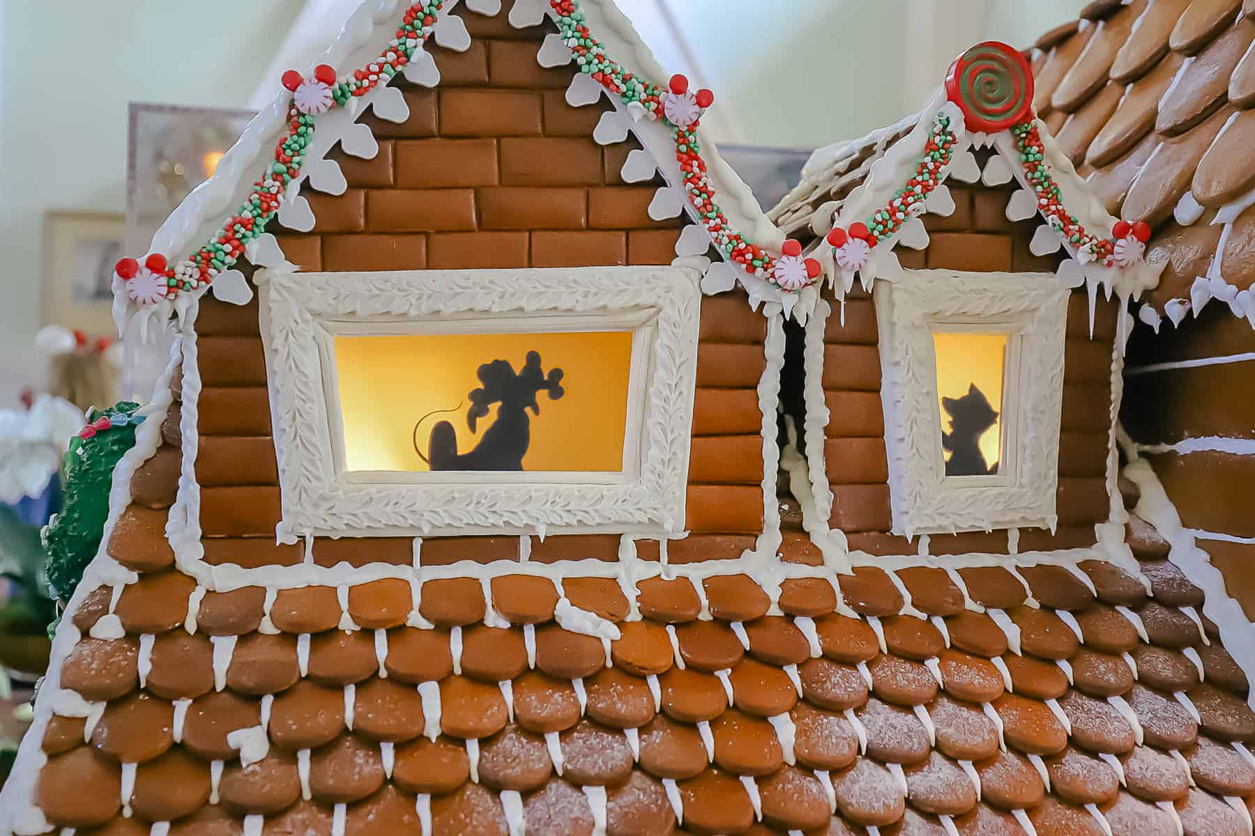 Silhouettes of Pluto and Figaro in the Boardwalk Inn's gingerbread house 