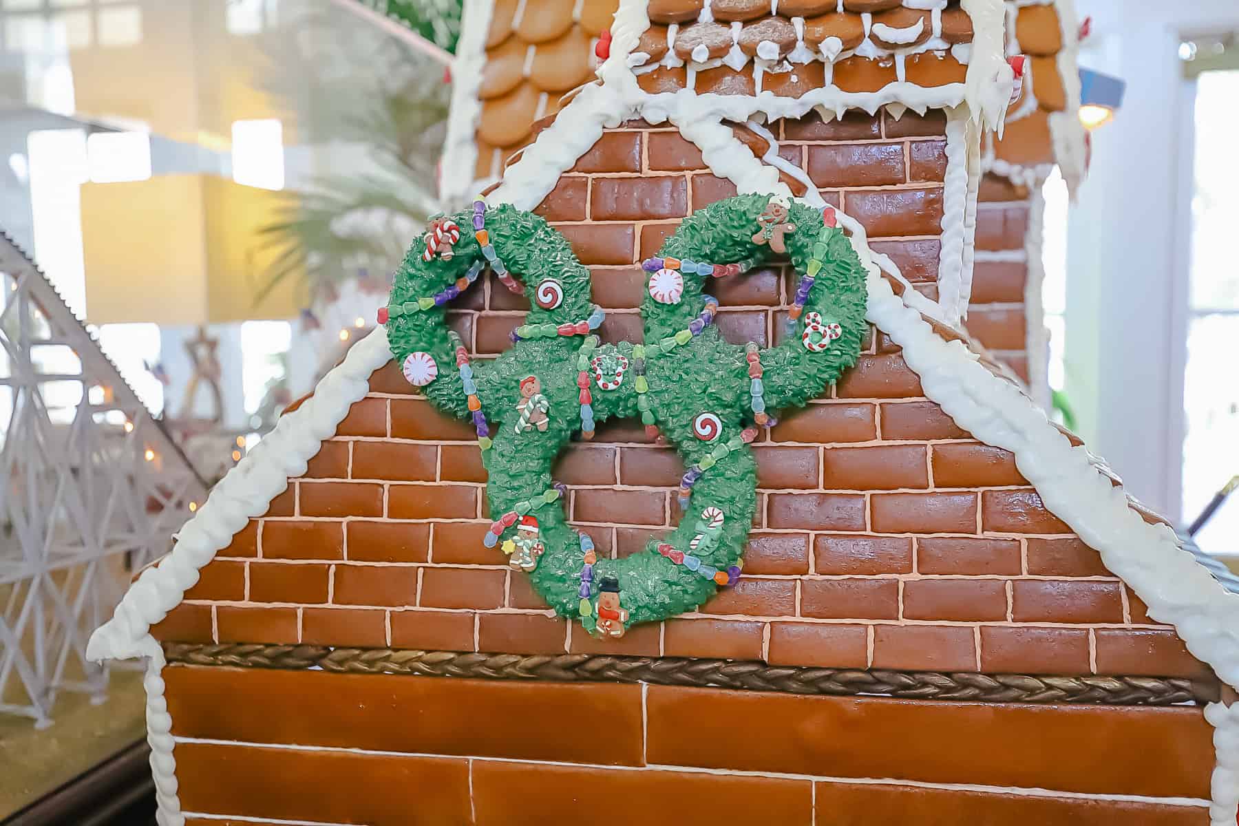 a Mickey Wreath on the side of the roof made with green drop stars and covered in candy 