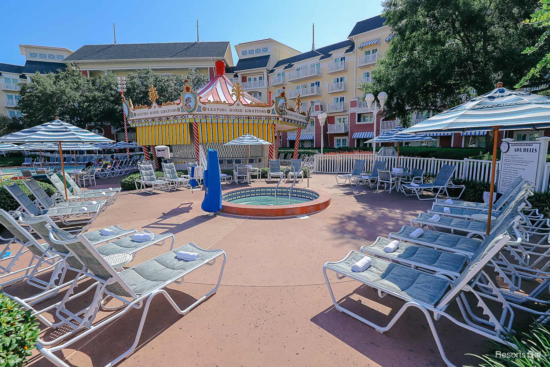 a small hot tub surrounded by loungers 