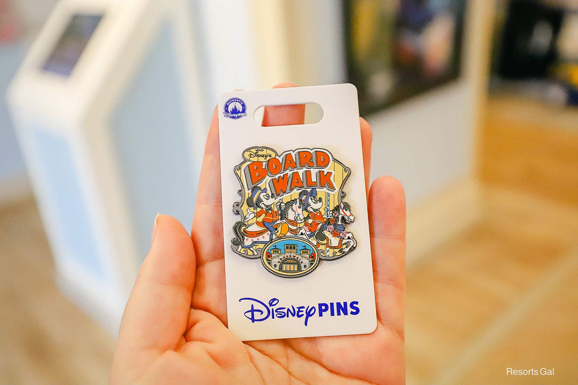 a pin representing the Boardwalk that features Mickey and Minnie Mouse