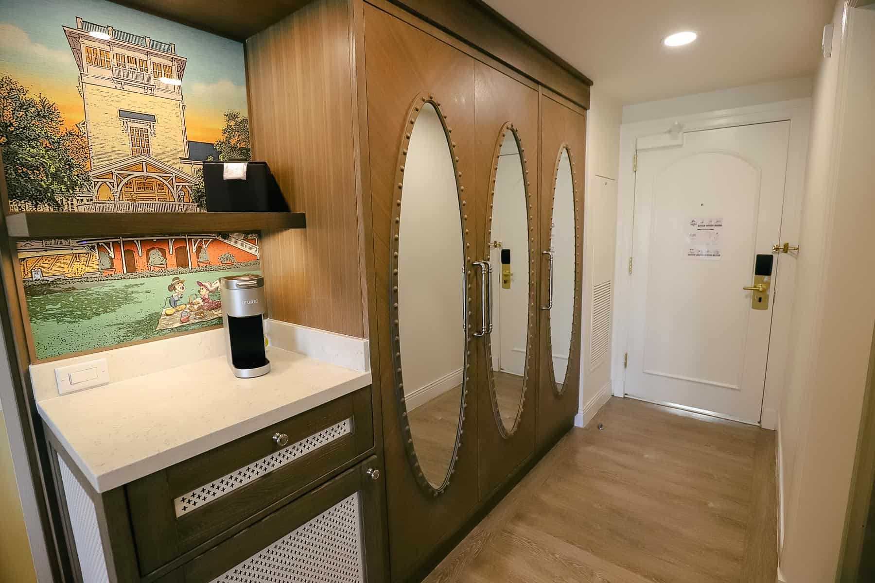 foyer of guest room that shows closet and coffee bar area