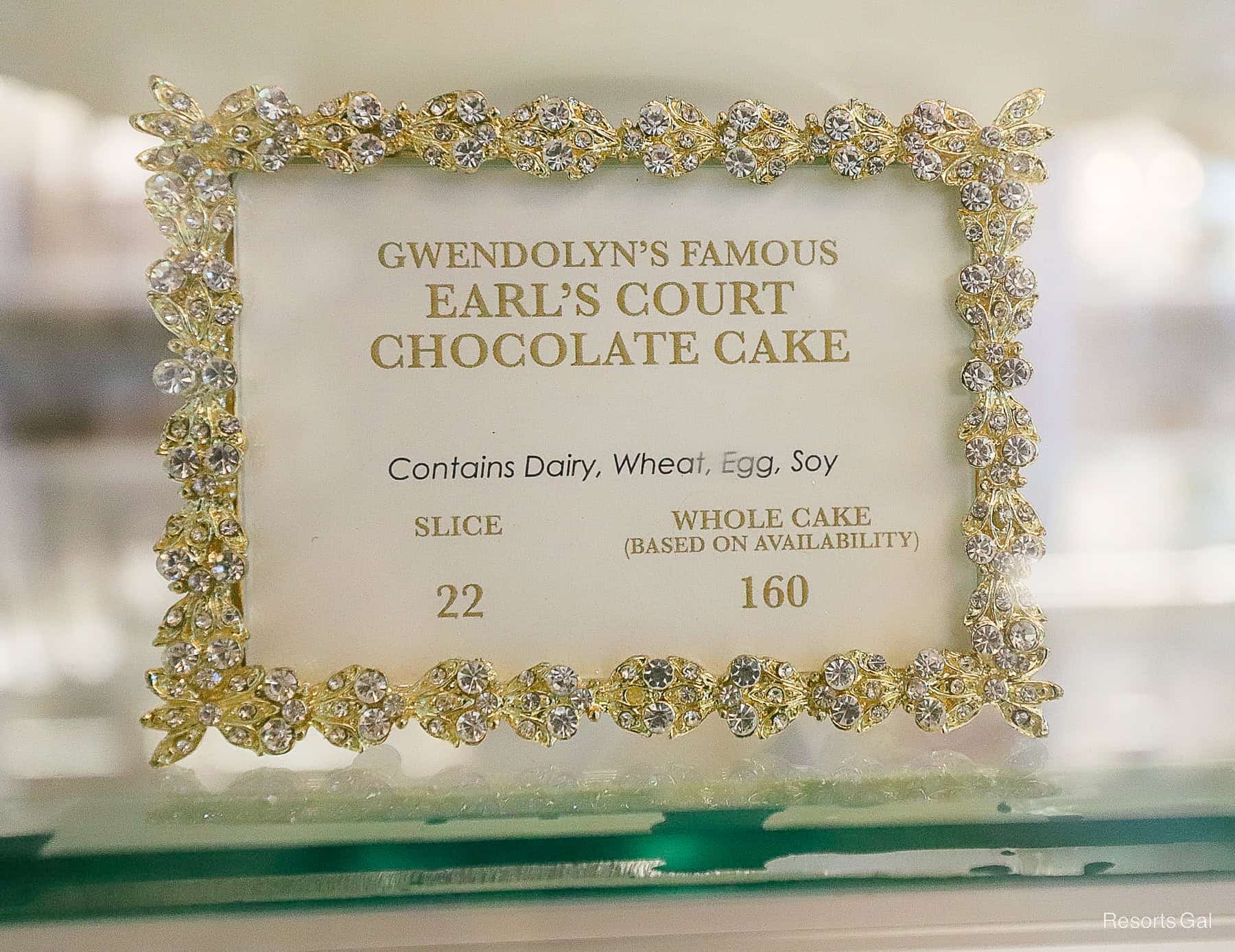 a sign with the price of a slice of Earl's Court Chocolate Cake at the bakery