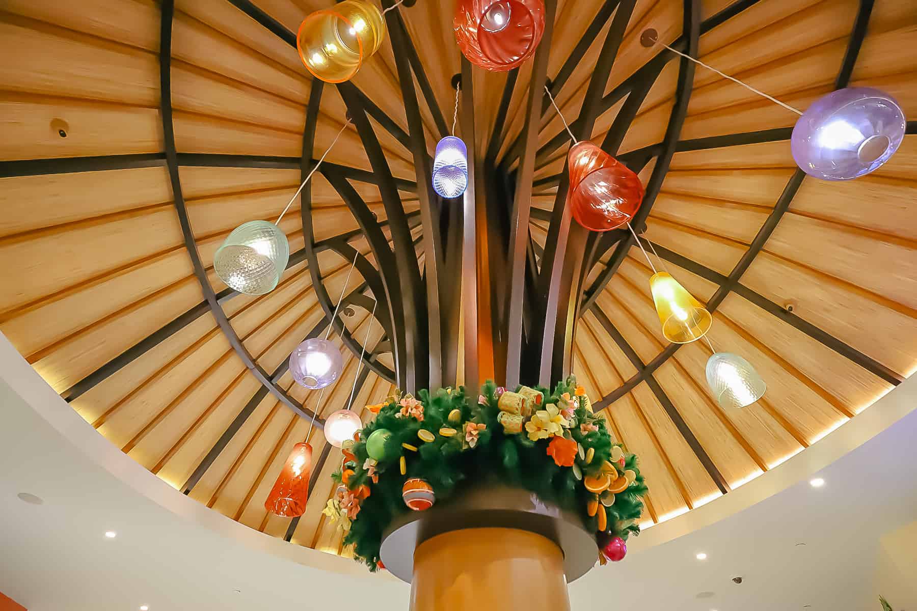 A light fixture that's wrapped in holiday garland at Disney's Caribbean Beach. 