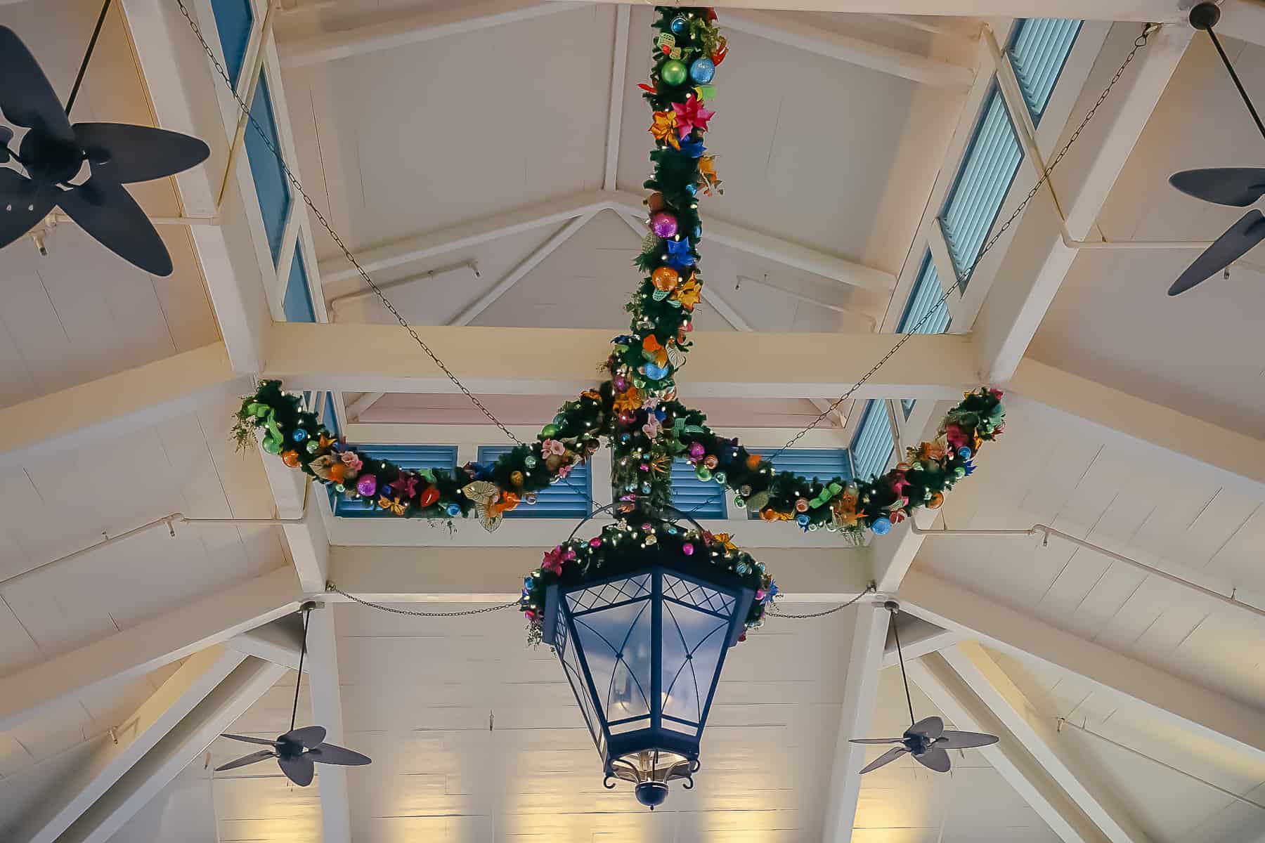 Garland wrapped around the main light fixture supports at the port co'chere. 