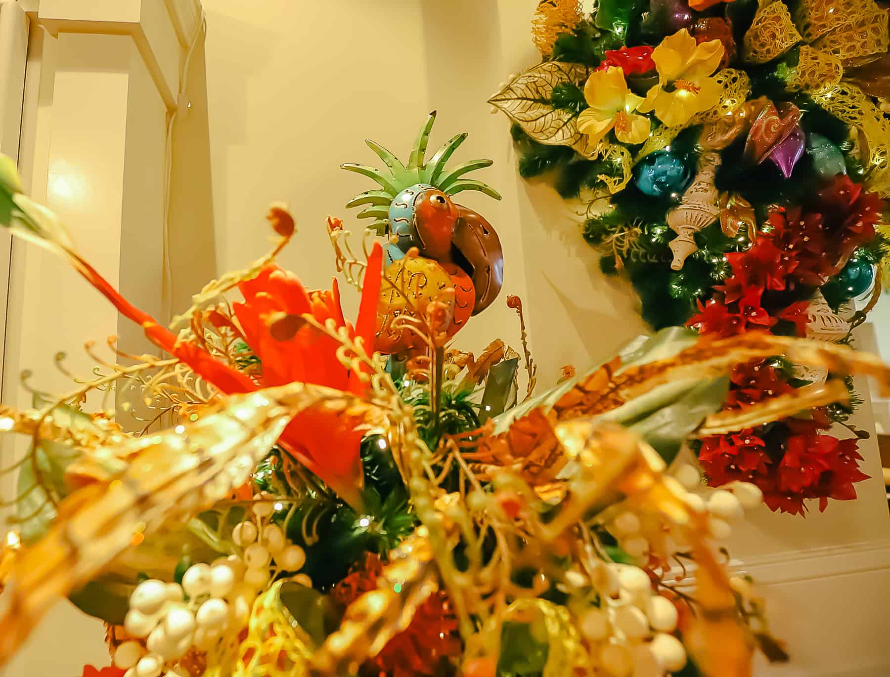 A tropical bird serves as a Christmas tree topper. 