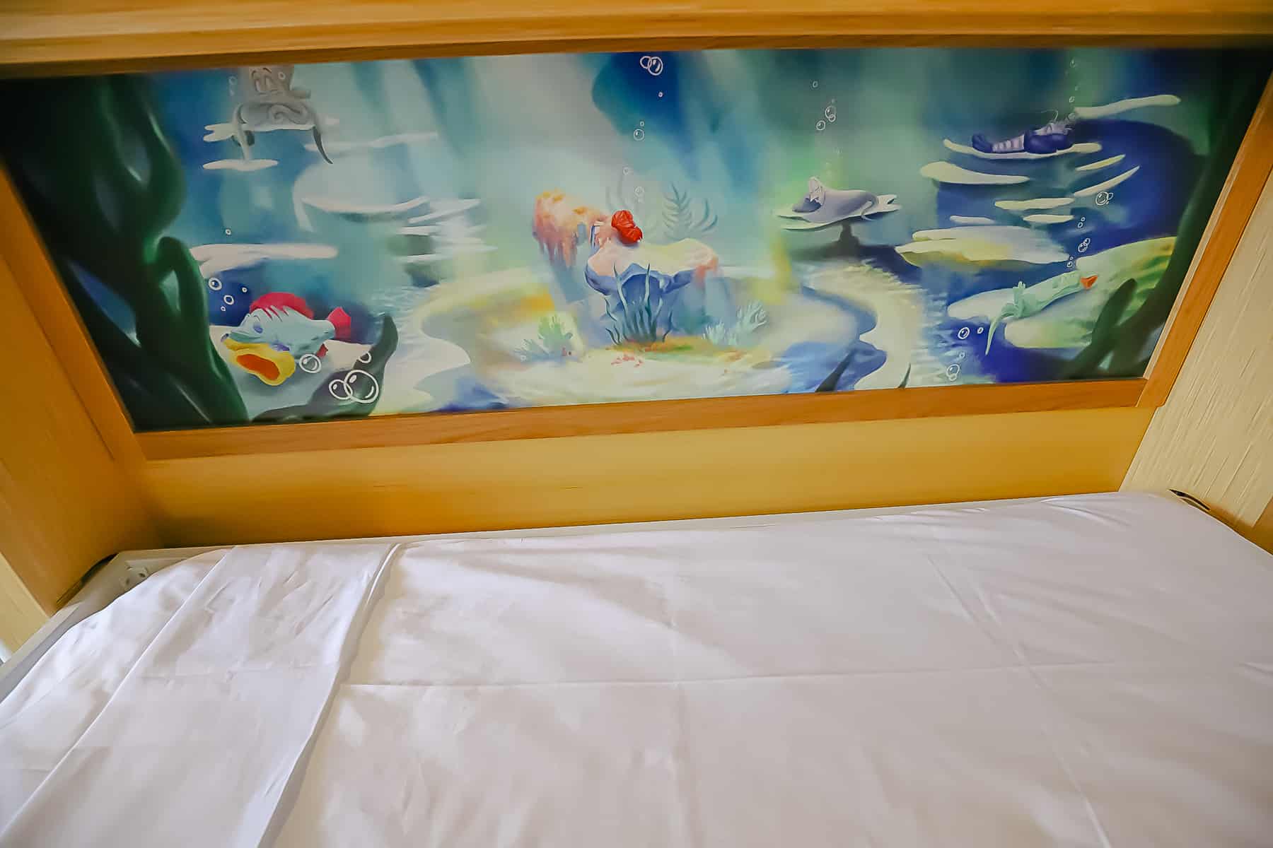 Artwork in the fifth sleeper bed that shows Sebastian from 'The Little Mermaid' sleeping. 