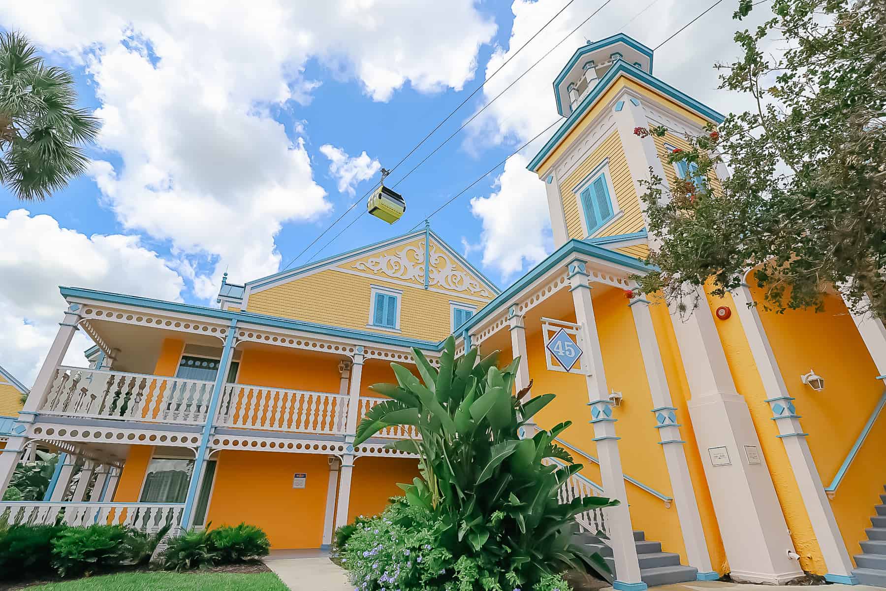The buildings in Jamaica at Disney's Caribbean Beach are yellow with blue and white trim. 