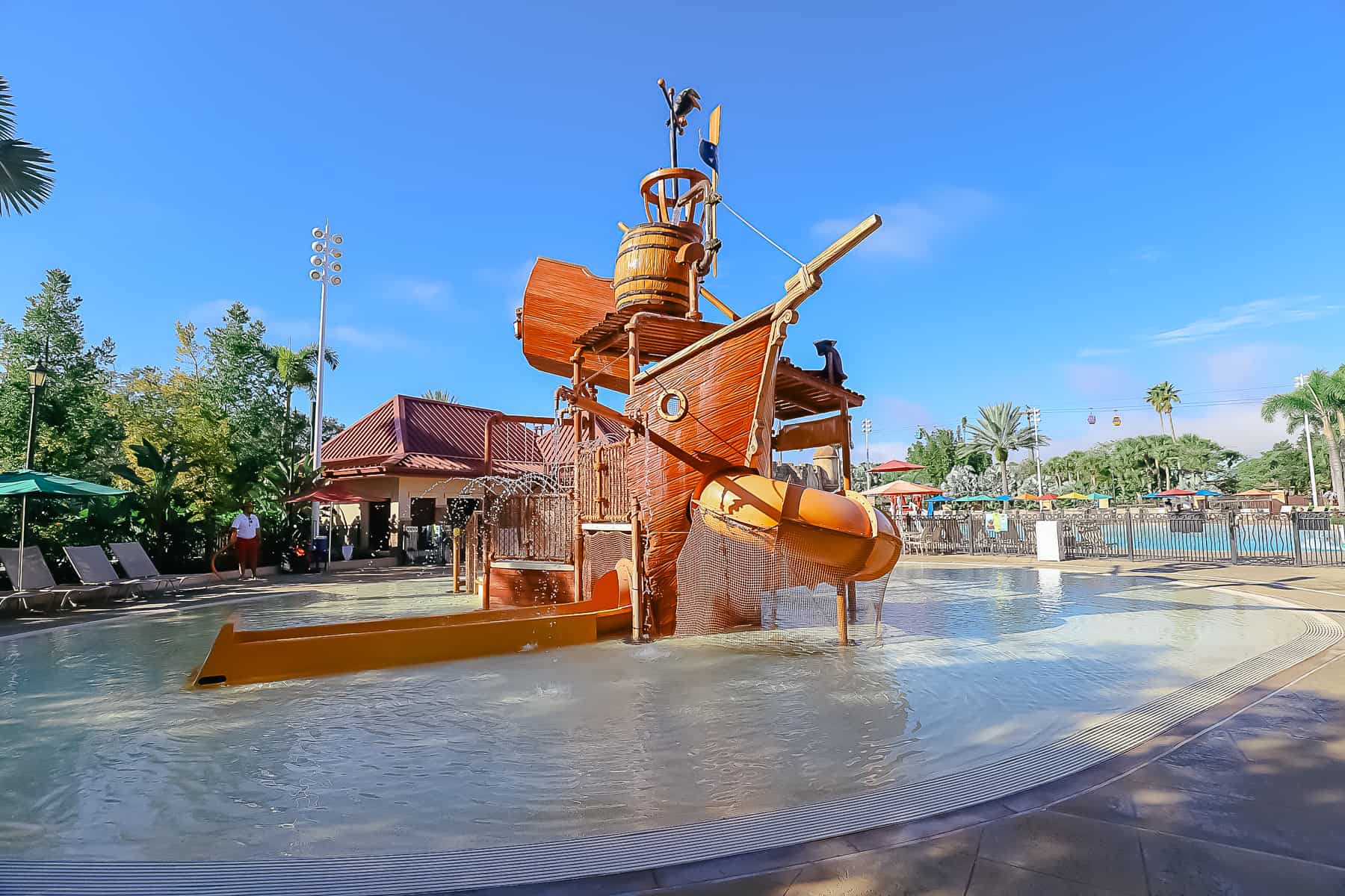 A splash pad with a water playground that resembles a shipwreck. 