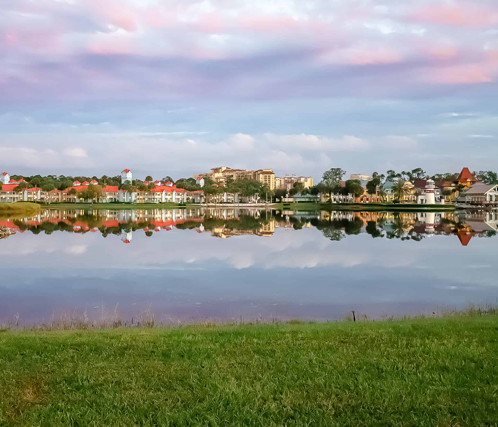 A sunset at Disney's Caribbean Beach with a reflection of the village in the lake. 