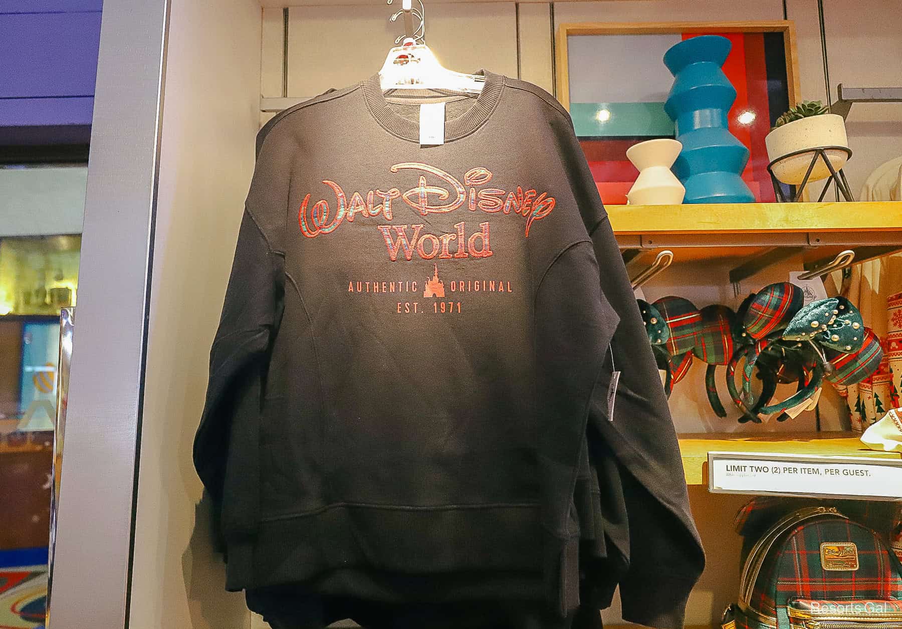 a black sweatshirt that says Walt Disney World in large red letters