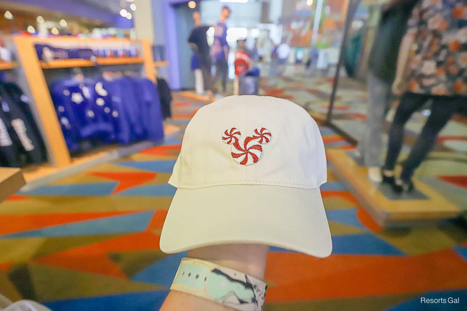 a solid cream hat with a peppermint Mickey 