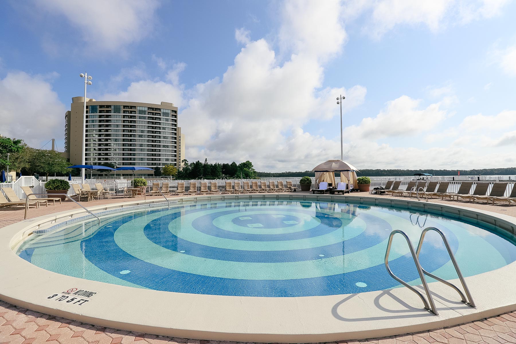 a pool with a view of Bay Lake Tower and Bay Lake 