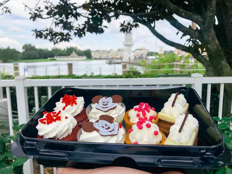 Dessert tray with various kinds of desserts like cupcakes and tarts.