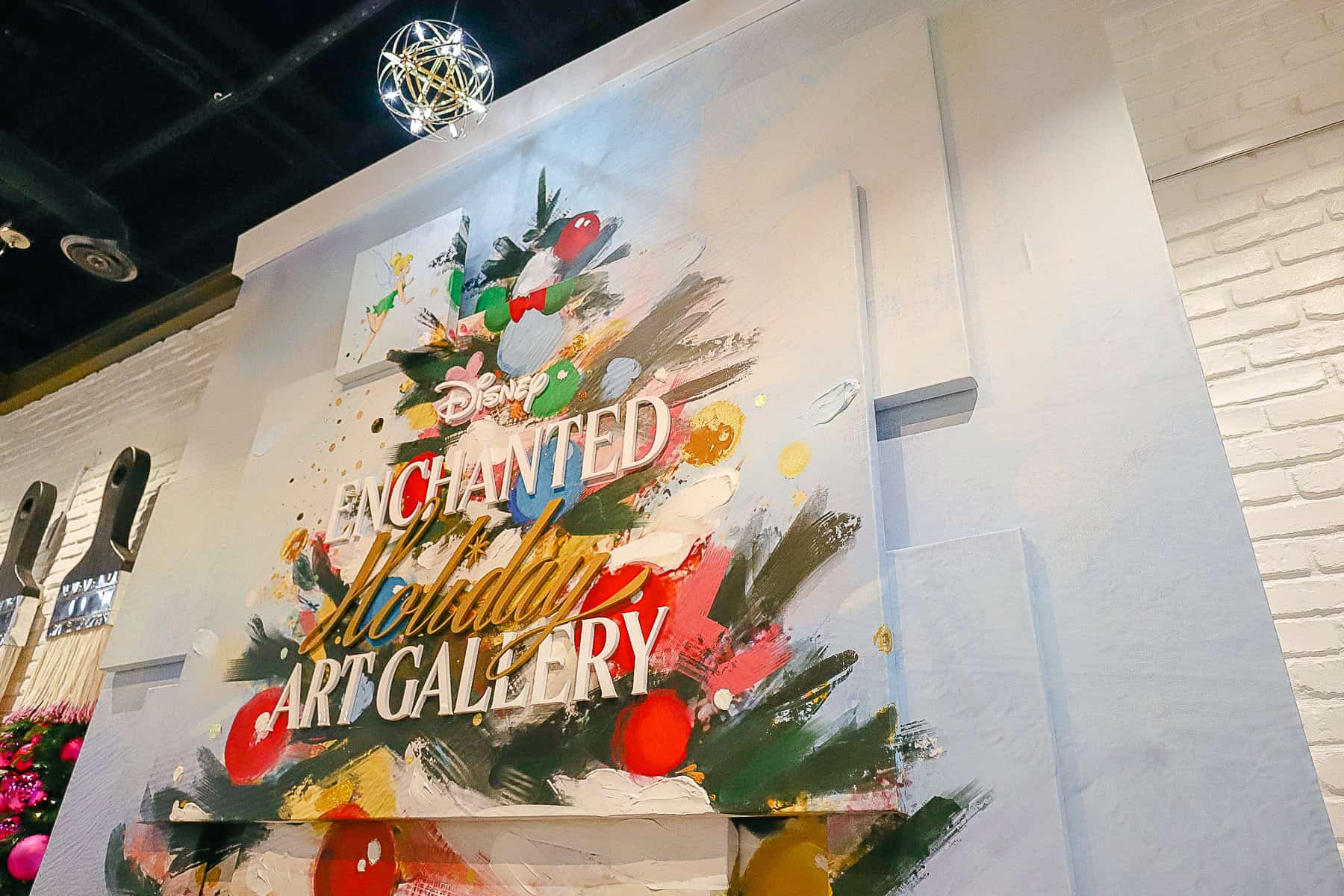 The Disney Enchanted Holiday Art Gallery sign behind the store's register.